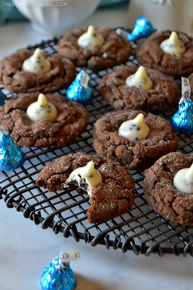 Chocolate cookies & cream cookies scattered on a black wire rack