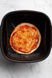 air fryer tortilla pizza cooked in air fryer basket