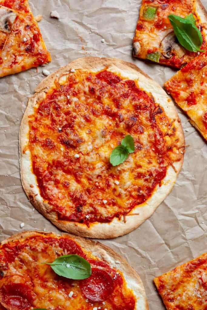 3 ingredient air fryer tortilla pizza on parchement paper